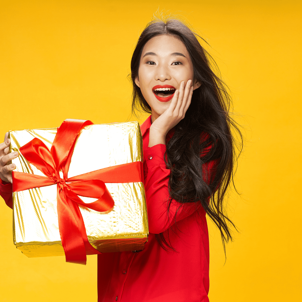 a lady holding a big box of gift